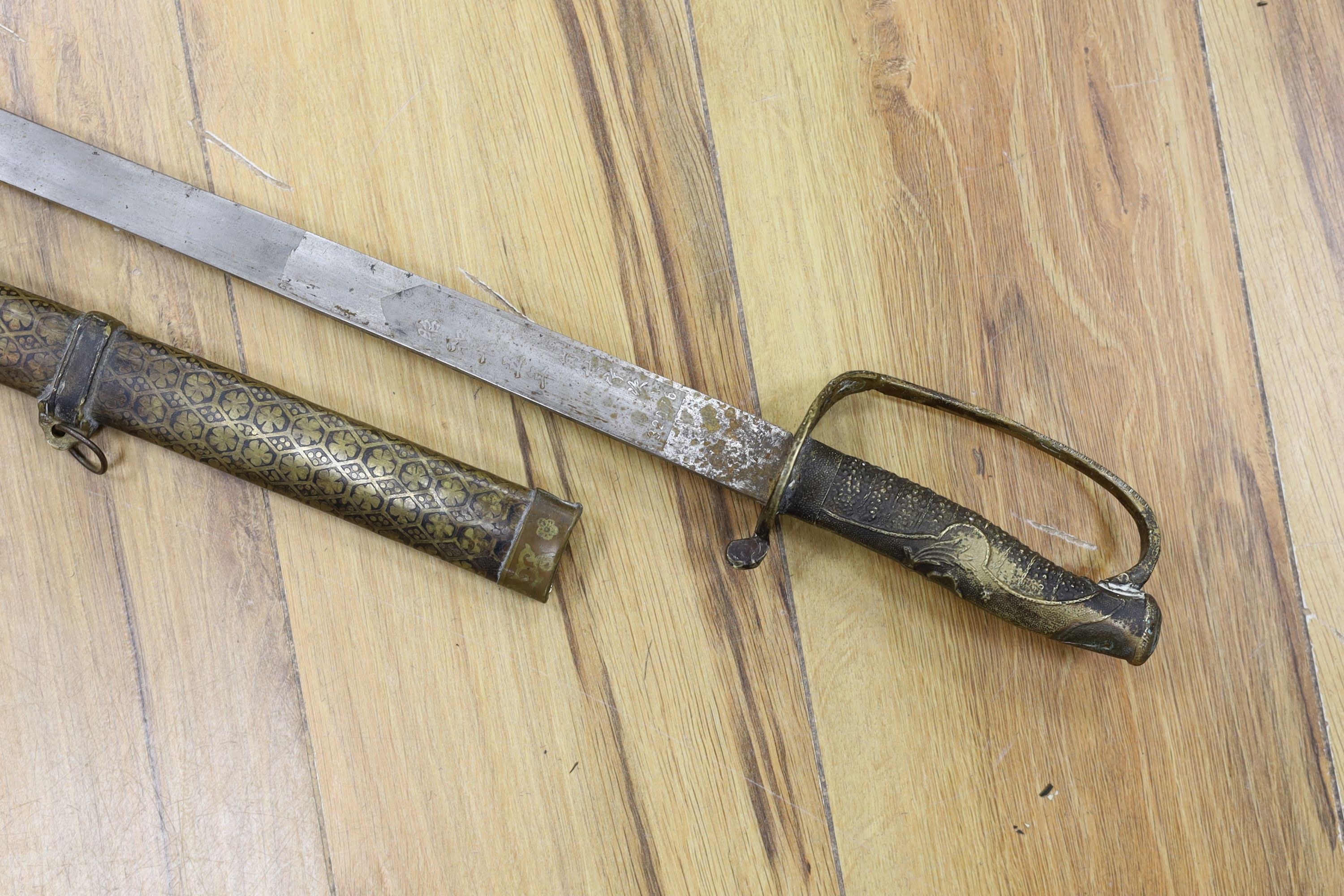 A Chinese sword, single edged blade 64cm long in etched brass scabbard